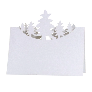 White 3D Christmas table place card with laser-cut pine forest silhouette and white paper base
