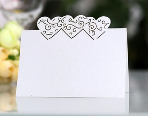 Detailed laser-cut white card featuring three interconnected hollow hearts on a mirrored surface