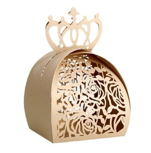Detail of laser-cut rose patterns on a gold crown-shaped wedding favor candy box