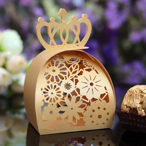 Detailed laser-cut gold crown candy box with intricate floral patterns for weddings