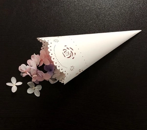 Detailed laser-cut white wedding confetti cone featuring intricate rose lace patterns
