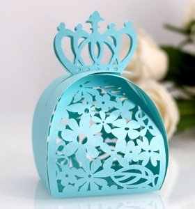 Macro detail of laser-cut crown gift box in light blue pearlescent paper for weddings