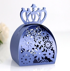 Close-up of laser-cut floral pattern and crown top on dark blue pearl paper gift box