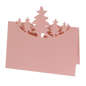 Macro detail of pink laser-cut Christmas tree place card with shimmering pearlescent finish