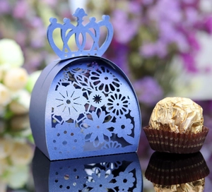 Macro view of blue laser-cut floral candy box with crown-shaped top for wedding decor