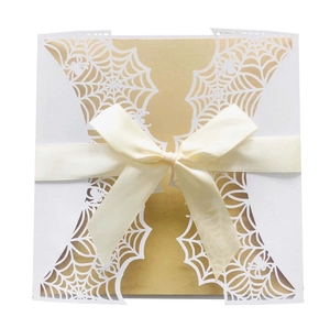 Laser cut spider web invitation card with gold liner and yellow silk ribbon bow