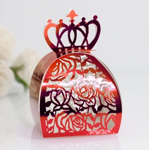 Detail view of laser-cut crown gift box with metallic red rose pattern and laser shine