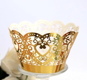 Golden laser-cut cupcake wrappers with heart patterns and elegant scrolled lace edges