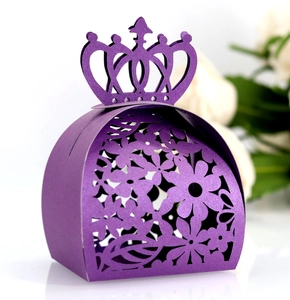 Detail of laser-cut crown gift box in purple with delicate hollowed flower patterns
