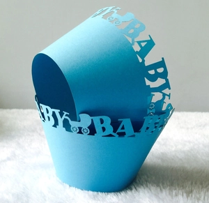 Detailed laser-cut bright blue cupcake wrapper with baby stroller design and BABY text