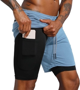 Detail view of double-layer sports shorts with side phone pocket for men's fitness