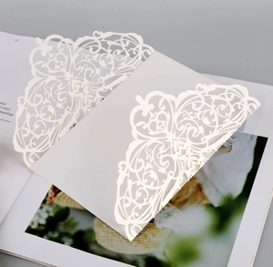 Detailed laser-cut floral pattern on white pearlescent paper wedding invitation cover