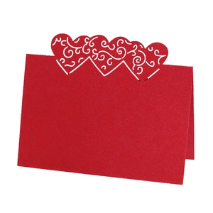 Elegant red laser-cut heart table card with intricate floral scroll patterns