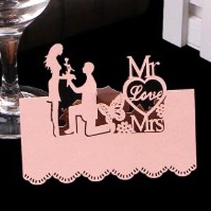Laser-cut pink Mr and Mrs wedding place card featuring a romantic proposal silhouette