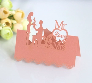 Detailed laser cut rose pink heart place card featuring romantic proposal silhouettes