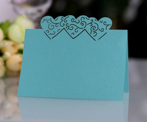 Detail of blue 3D hollow heart place card with intricate laser-cut scroll patterns