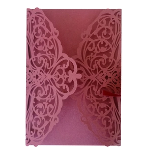Laser cut invitation cover in dusty rose pink with intricate floral symmetrical patterns