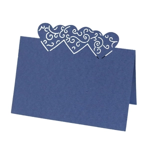 Detail of laser-cut heart pattern on navy blue place card for wedding table setting
