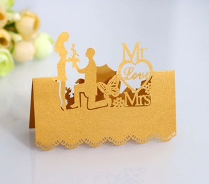Detailed laser-cut golden place card with 3D heart, butterfly, and Mr & Mrs text