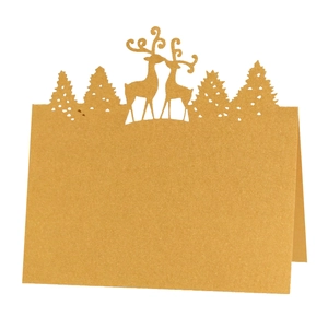Detailed laser-cut kraft paper Christmas place card featuring reindeer and pine tree silhouettes