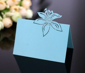 Detailed laser-cut light blue wedding place card with elegant lily flower pattern
