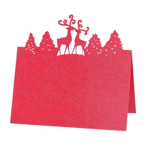 Detailed laser-cut red paper place card featuring a Christmas reindeer and forest silhouette