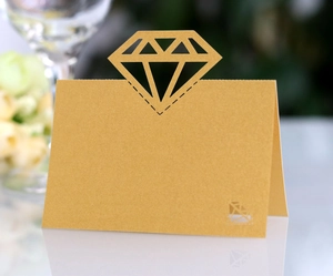 Detail of laser-cut gold diamond shape hollow place card on pearlescent paper