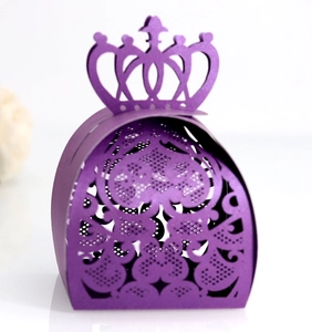 Detail view of purple laser-cut candy box with crown top and intricate lace pattern