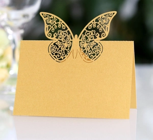 Laser-cut butterfly place card in pearlescent gold cardstock for wedding table settings