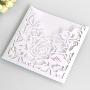 Vue détaillée de l'invitation découpée au laser avec motifs de roses blanches élégantes