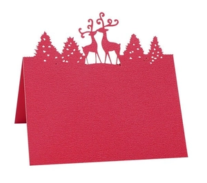 Detail of red laser-cut Christmas reindeer place card with fine paper texture