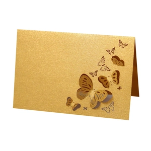 Detail of 3D laser-cut hollow butterfly place card with golden glitter texture finish