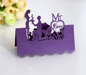 Detail of laser-cut purple place card with heart silhouette and elegant lace pattern