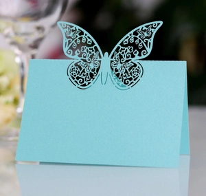 Close-up of laser-cut light blue butterfly place card with pearlized shimmer finish