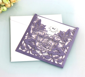 Detailed laser cut purple floral wedding invitation with white insert card and envelope