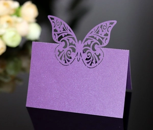 Detailed close-up of a laser-cut purple butterfly place card with pearlescent finish