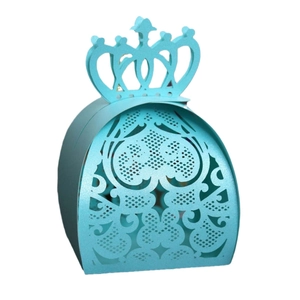 Detail of light blue laser-cut candy box featuring a crown top and intricate floral patterns