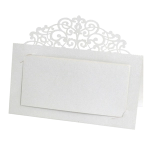 Macro detail of laser-cut lace pattern on pearlescent white wedding table place card
