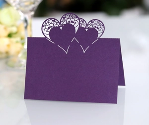 Detailed laser-cut hollow heart place card in purple for romantic wedding table decor