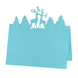 Laser cut sky blue reindeer and pine tree place cards with glitter finish for table decor