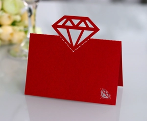 Detail of red diamond laser-cut wedding place card with elegant folding design