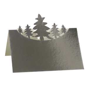 Detailed close-up of a silver laser-cut Christmas tree place card with metallic texture