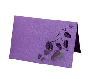 Macro detail of laser-cut 3D purple butterfly place card with sparkling glitter texture