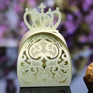 Detail of laser-cut wedding candy box with heart patterns and crown top