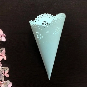 Mint green laser-cut wedding flower confetti cone with rose patterns on wood background