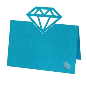 Detail of teal wedding place card featuring laser-cut 3D diamond design on premium paper