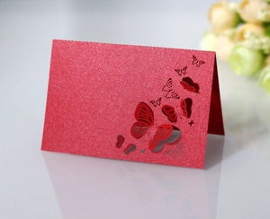 Detail of red glitter card with laser-cut hollow butterfly and 3D folding wing design