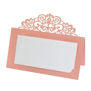 Detailed laser-cut hollow lace design on a coral pink wedding name place card