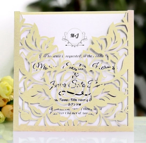 Detail of laser-cut rose patterns on elegant champagne gold wedding invitation card