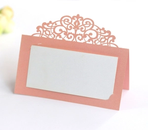 Detailed laser-cut rose gold wedding place card with intricate European lace patterns